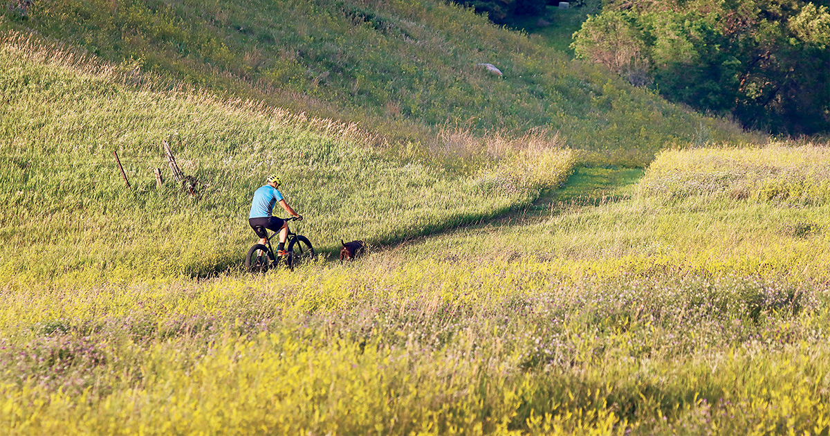 Person riding bike in park. Photo by Craig Bihrle