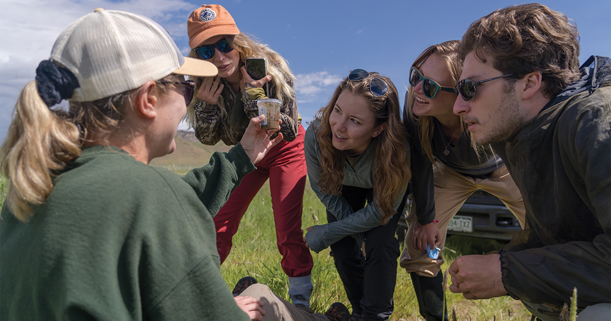 Scientists discussing soil photo by Derek Christians, DU
