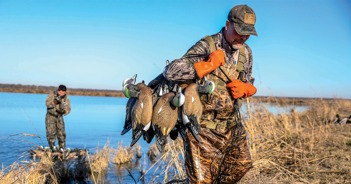 Duck hunter carrying decoys. Photo by John Hoffman, Ducks Unlimited