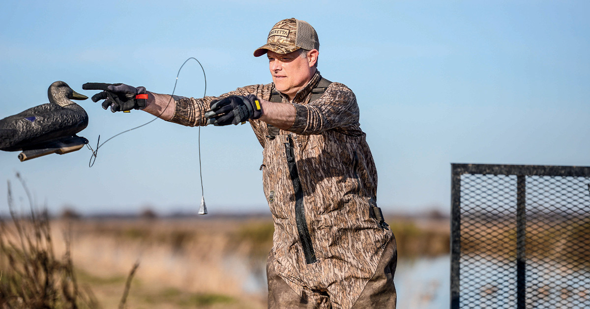 .Duck hunter throwing decoy out. Photo by John Hoffman, Ducks Unlimited