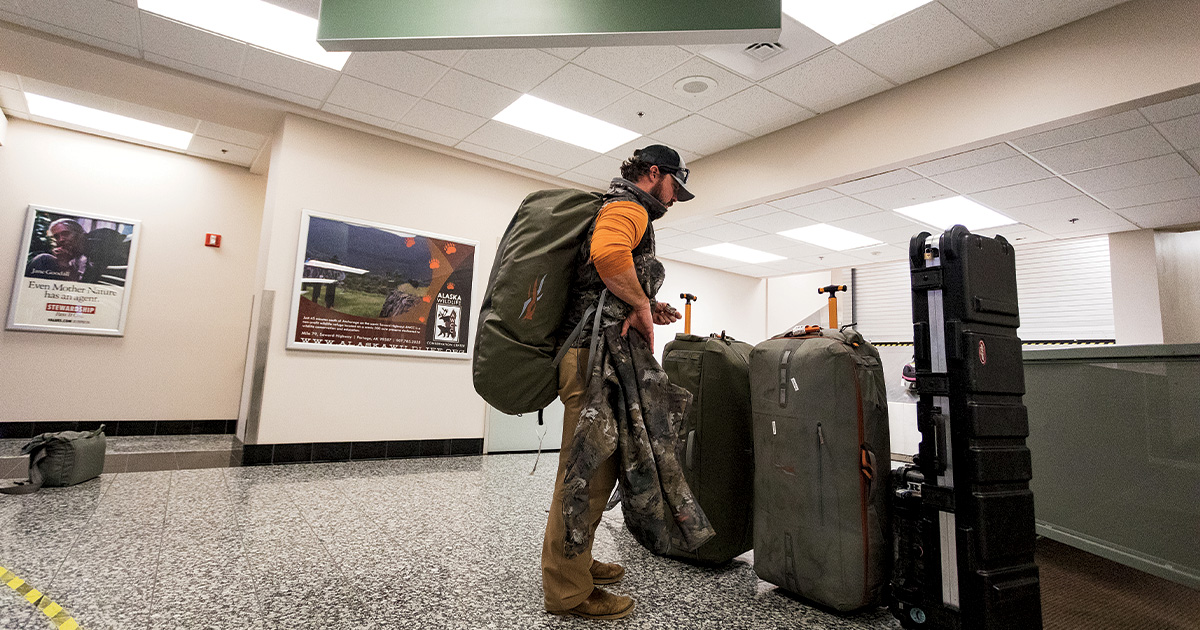 Traveler with hunting gear at airport. Photo by Matt McCormick/ImagesOnTheWildSide.com