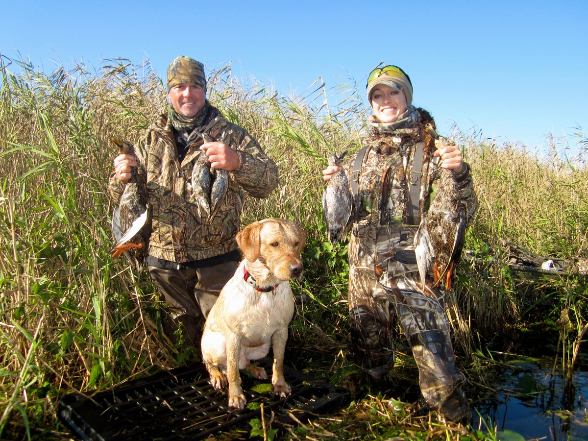 Duck hunters and retriever. Photo courtesy of Florida Fish and Wildlife Conservation Commission