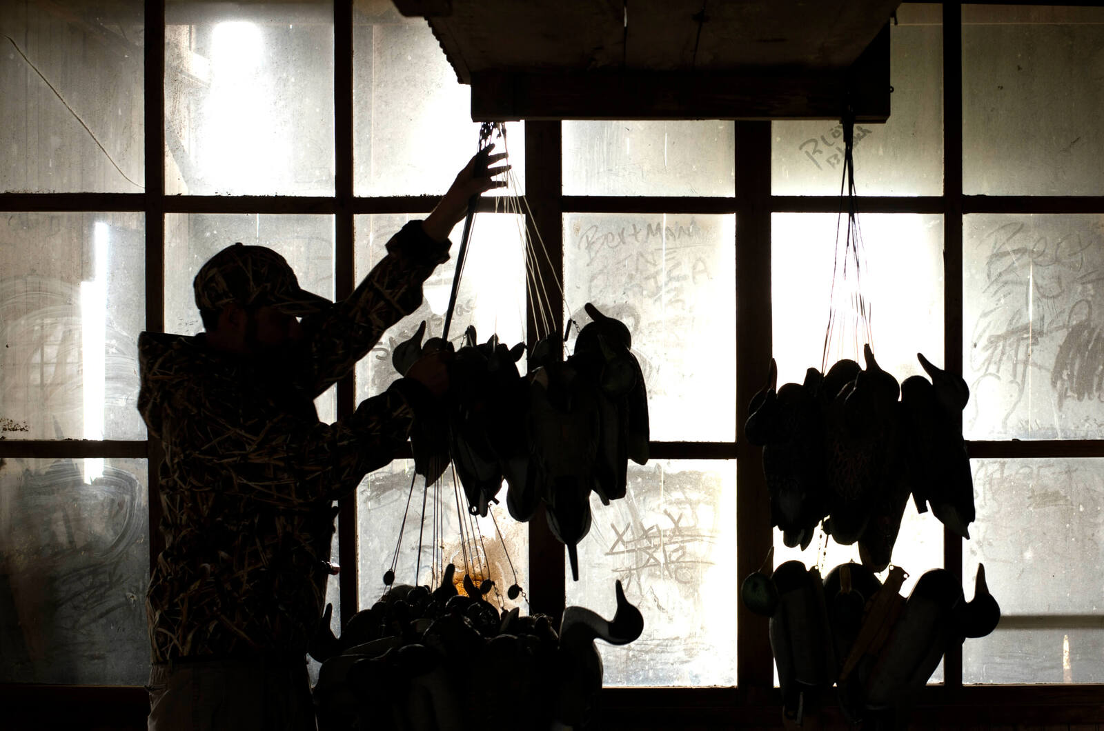 Young hunter storing ducks on strings