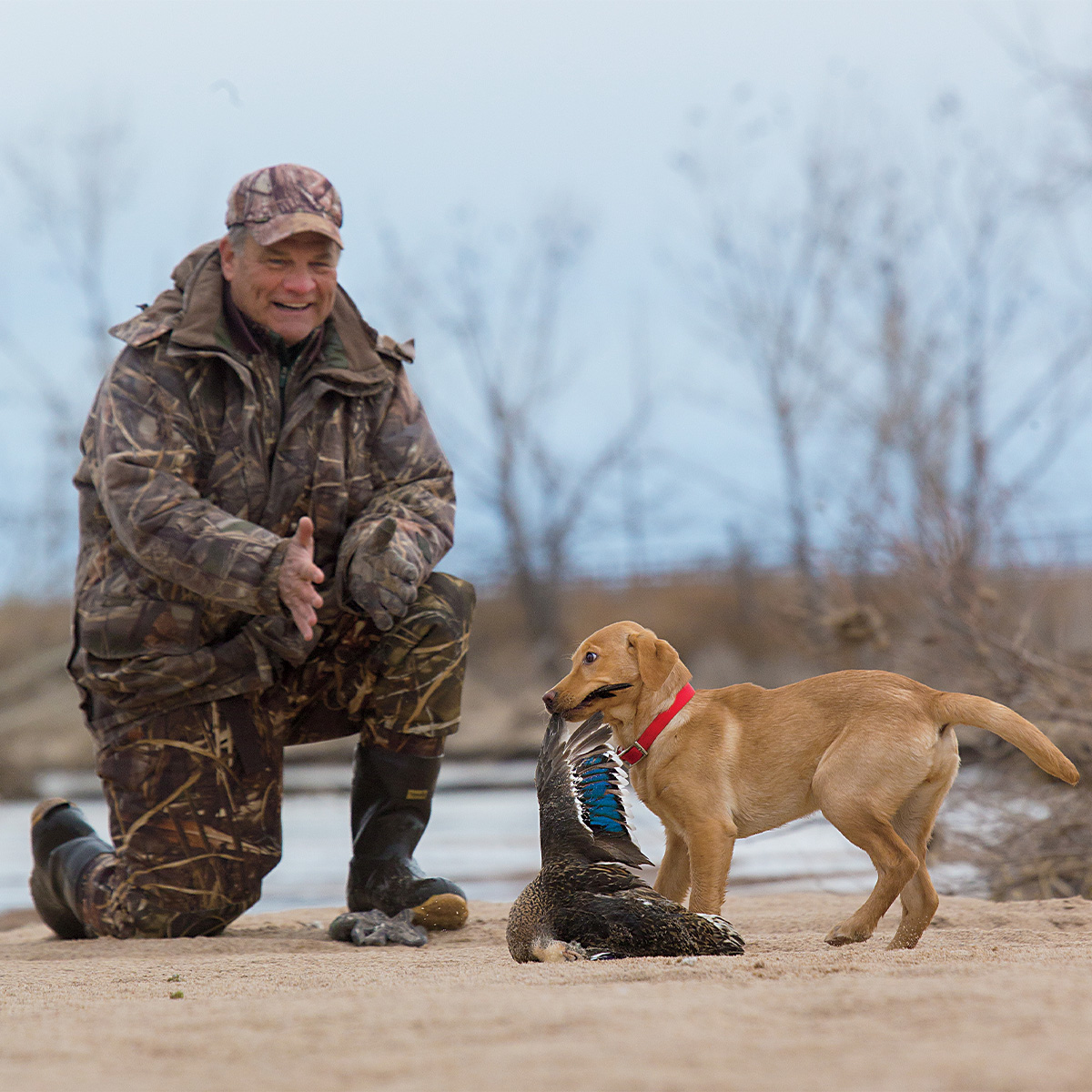 Hunter and puppy during a training session with real bird. Photo by DougStienkePhotos.com